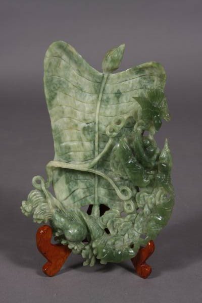 Green Jade Leaf Form Dish, Chinese, 20th Century: Leaf form dish. Chinese, 20th century. Green jade. A flattened leaf with vines surrounded by clouds, birds, and bats. Length 10", width 7".