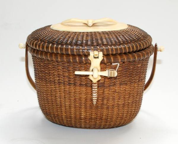 Nantucket Lightship Basket, Jose Reyes, 20th C.: A Nantucket Lightship basket (Friendship basket). American, circa 1952-1955. Made by Jose Formosa Reyes for the Waine family, Nantucket Island, Nantucket. The oval basket with swing handle, ivory knob