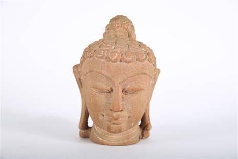 Southeast Asian Carved Sandstone Buddha Head: Carved sandstone. Height: 6 1/2", Length: 4 1/2", Depth: 4 1/2". Carved sandstone head of a Buddha with curled hair. In marker on the neck is written "No. 5".