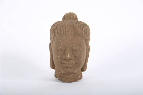 Cambodian Carved Sandstone Head of a Buddha: Carved sandstone. Height: 6 3/4", Length: 3 1/2", Depth: 4 1/2". Cambodian carved sandstone head of a Buddha with straight hair.