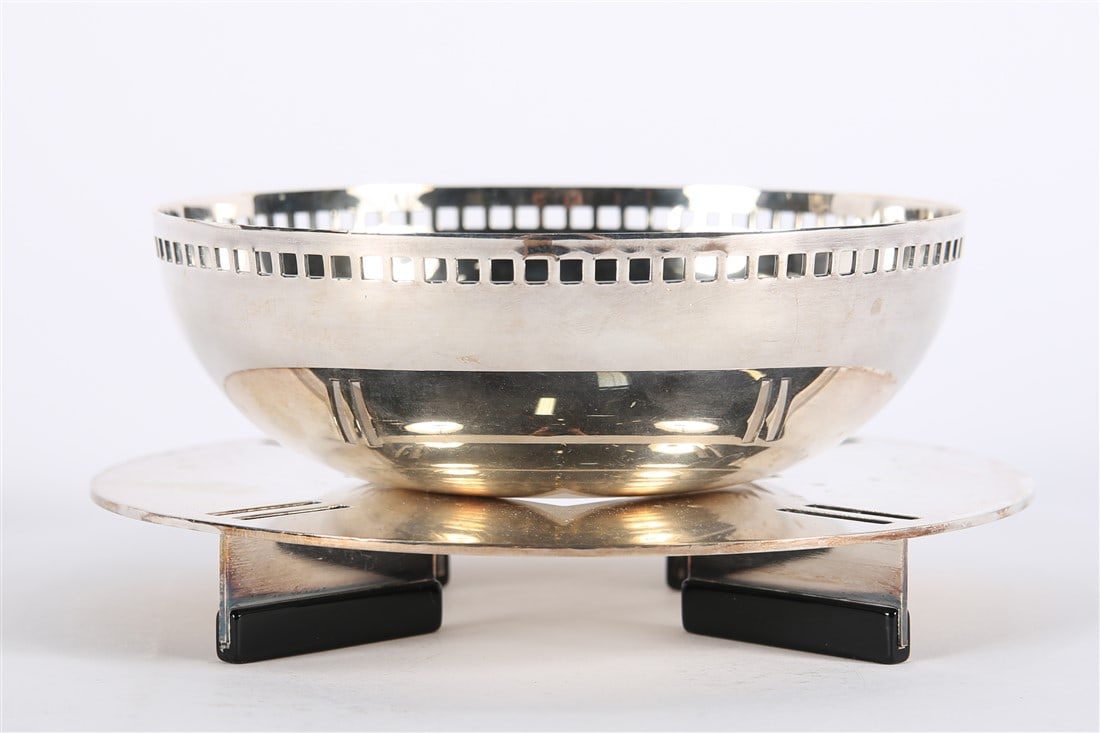 Swid Powell, Stainless Steel Candy Dish: Swid Powell. Stainless steel, enamel. Bowl: Height: 2", Diameter: 6". Stand: Height: 1", Diameter: 7". Stainless steel candy dish with stand by Swid Powell. Marked to the underside.