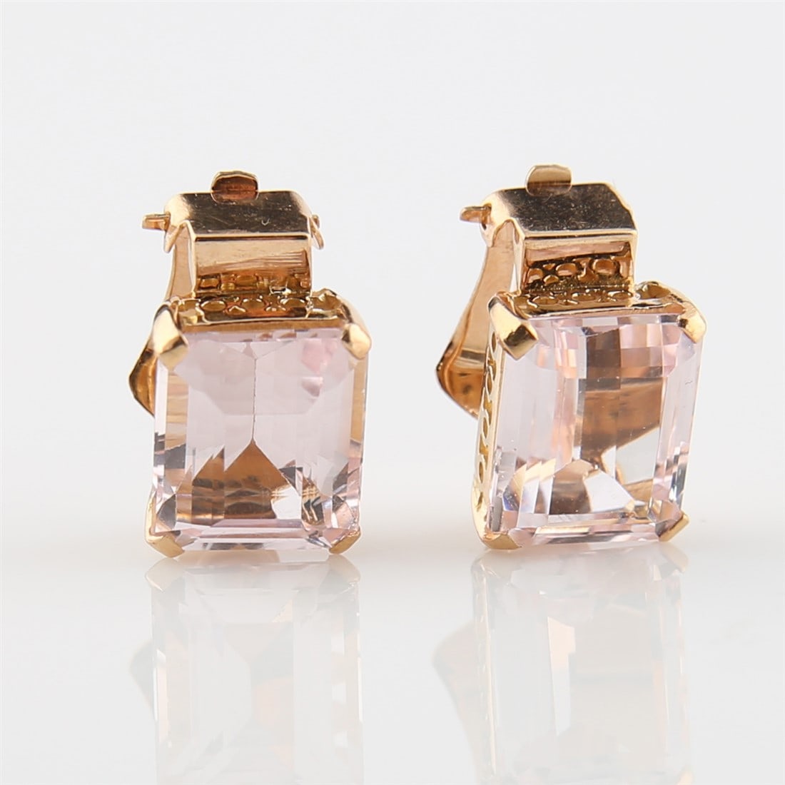 18k Rose Gold Beryl Morganite Clip On Earrings: Beryl Morganite stones: 10.0cts TW (est). Total weight (including stones): 6.6g. Yellow gold clip-on earrings with rectangular Beryl Morganite stones. Tests at 18k. Appears unmarked.