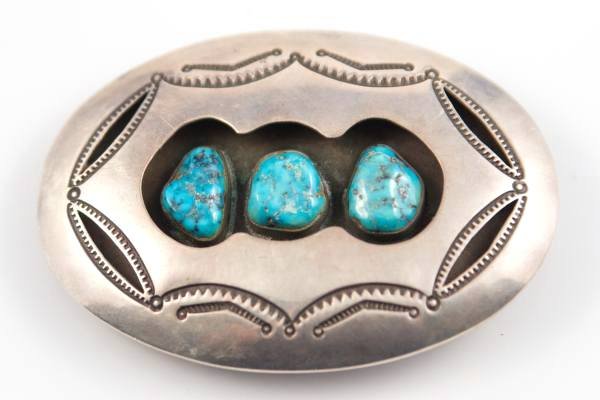Belt Buckle, Silver & Turquoise, Navajo, 20th C.: An oval shadow box style silver belt buckle set with three turquoise stones. Navajo, mid-20th century. Signed "Handmade, Aaron Chischiligi, Navajo." 59 grams. Weighed with stones. Length 3/4", width 2