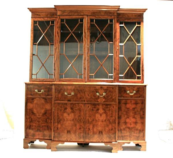 George III Style Mahogany Breakfront Secretary: George III style mahogany breakfront secretary bookcase. English, 20th century. Projecting molded cornice over mullion glazed doors above center pull at secretary with fitted interior over four cupboa