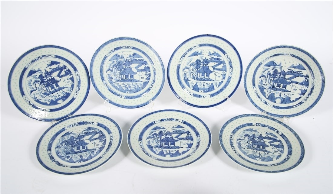 Collection of Nine Chinese Rice Patterned Plates: Porcelain. Diameter: 10 1/4". Blue and white Chinese porcelain plates with rice pattern within the surface. "China" handpainted to reverse of each.