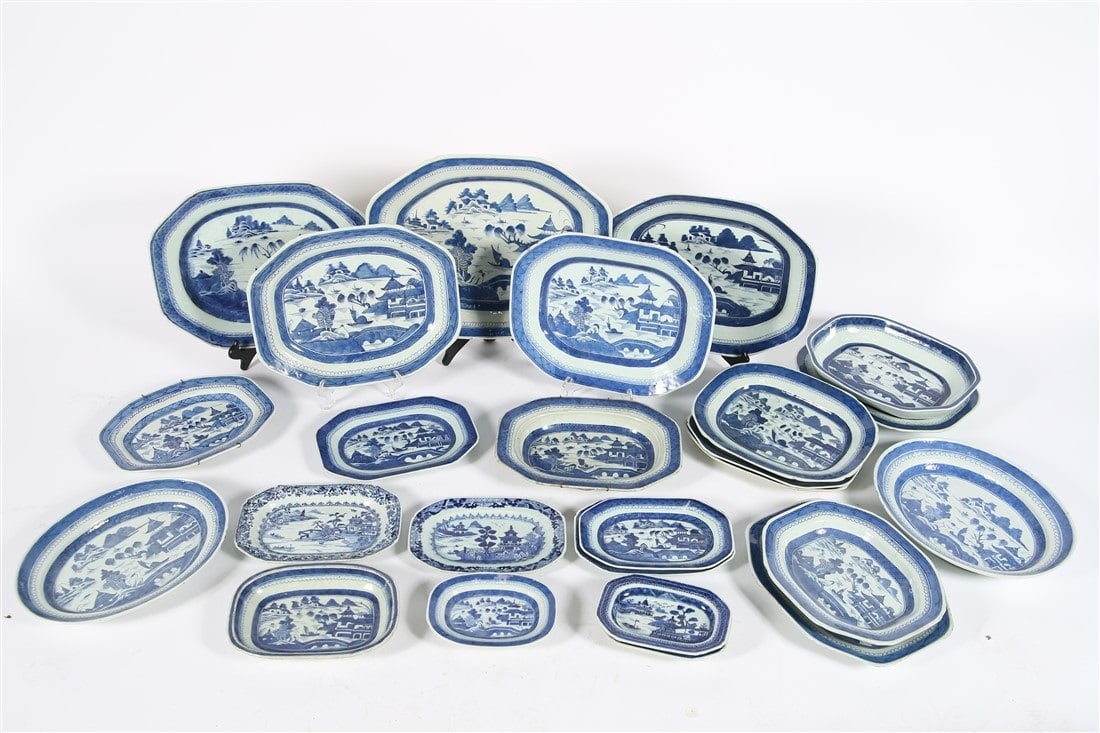 Collection of 25 Chinese Pottery Items: Porcelain. Largest: 14 3/8" x 17 1/2". Smallest: 5 1/4" x 7 5/8". Collection of twenty-five oval/rectangular platters and dishes. Largest platter has a sticker to the underside from the James Gallery 