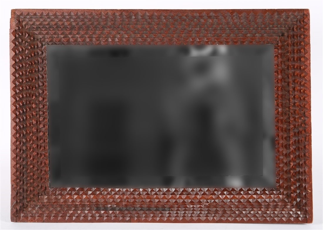 Carved Wood Tramp Art Mirror: Carved wood, glass. 20" x 28 1/4". Carved wood frame tramp art mirror with beveled mirror glass.