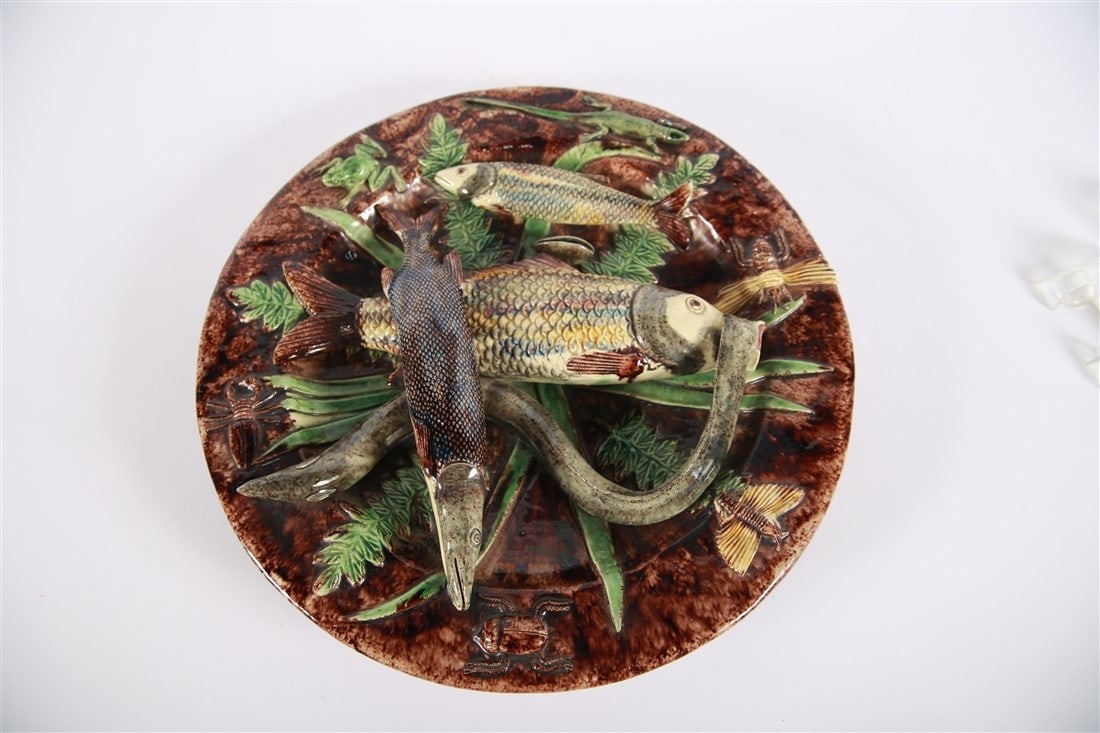 Manuel Mafra, Palissy Majolica Fish Charger: Manuel Mafra (Portuguese, 1831-1905). Glazed ceramic. Diameter: 15". Majolica plate or charger depicting fish, lizards, and insects. Made in Portugal. Marked to the underside with Manuel Mafra's stamp