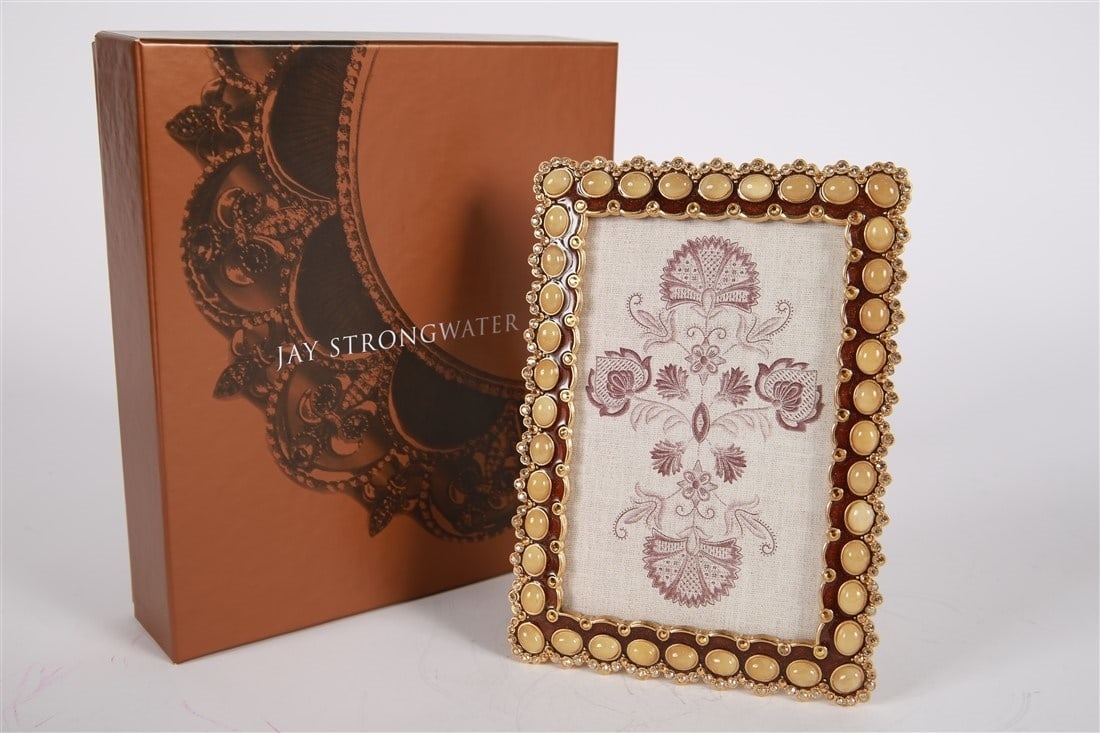 Jay Strongwater, 4x6 Golden Cabochon Frame: Jay Strongwater (American, established 1995). Enamel, metal. Collection: Classics. Frame: 7 1/2" x 5 1/4". Sight: 5 3/4" x 3 3/4". Gold tone metal and rhinestone embellishment with brown enamel and be