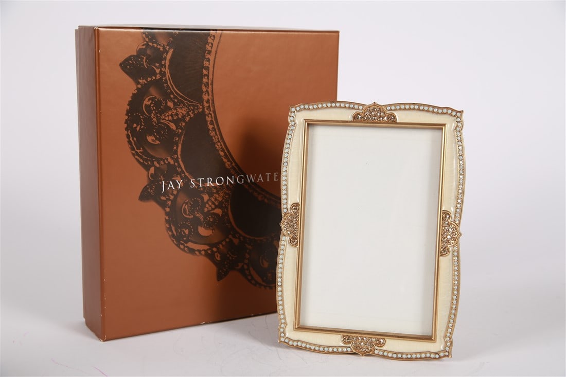 Jay Strongwater, 4x6 Golden Scalloped Frame: Jay Strongwater (American, established 1995). Enamel, metal. Collection: Golden Peacock. Frame: 7 1/2" x 5". Sight: 5 3/4" x 3 1/2". White/Cream colored enamel with rhinestone embellishments and scall