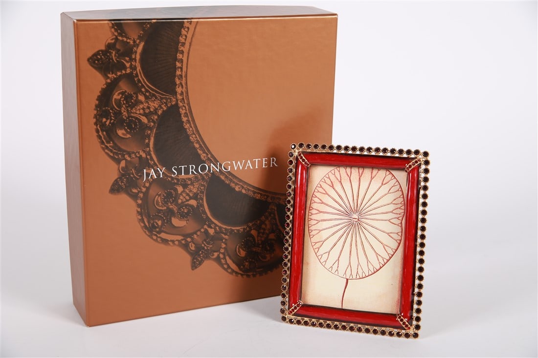 Jay Strongwater, 3x4 Red Stone Edge Frame: Jay Strongwater (American, established 1995). Enamel, metal. Frame: 5 1/8" x 4 1/4". Sight: 3 3/4" x 3". Gold tone metal and red toned enamel surrounded by red rhinestone edge, additional rhinestone d