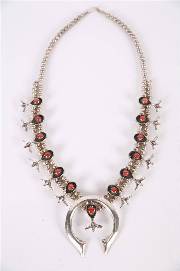 Silver and Coral Squash Blossom Necklace: Silver, coral. Chain length: 24". Pendant: 2 3/4" x 2 1/4". Silver beaded double-layered chain with pendant. No apparent markings.