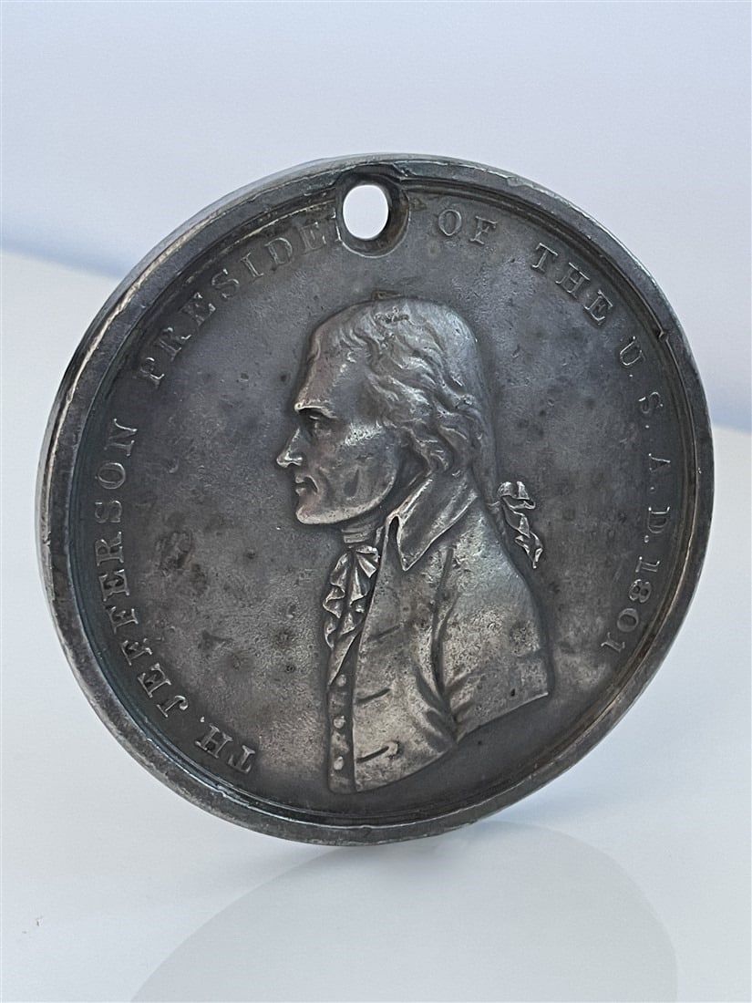 Jefferson Peace Medal Restrike: Metal. Diameter: 3". Restrike of the original 1801 Jefferson Peace Medal designed and engraved by John Reich. Front of the metal is inscribed, "TH. Jefferson President of the U.S. A.D. 1801" surroundi