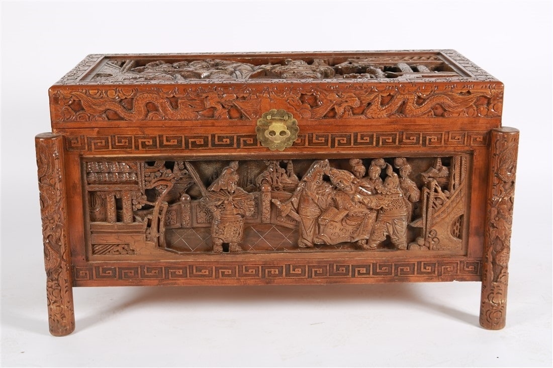 Carved Chinese Wood Chest: Carved wood. Height: 24", Length: 43 5/8", Depth: 23 1/4". Carved wood Chinese chest decorated with figural scenes of warriors in battle regalia.