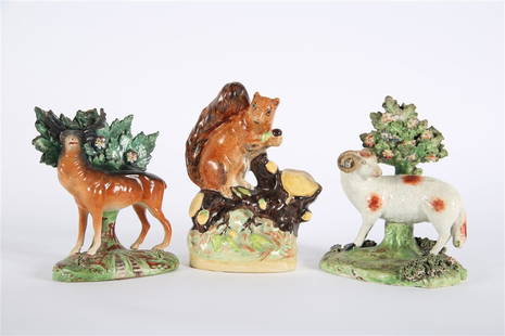 Three Staffordshire Animal Figurines: Ceramic. Ram: Height: 5 3/4", Length: 4 3/4", Depth: 3 1/4". Deer: Height: 5 1/4", Length: 4", Depth: 2 1/4". Squirrel: Height: 6 1/2", Length: 3 1/2", Depth: 2 1/4". Collection of three