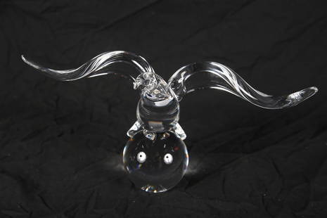 Steuben, "Eagle" Figurine: Steuben Glass Works (American, established 1903). "Eagle". Crystal. Designed by James Houston, 1964. Design: 8130. Height: 6", Length: 12 1/2", Depth: 4". Crystal eagle perched atop a ball. Etched "St