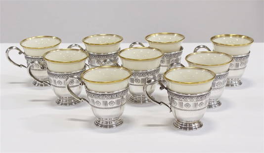 Lenox, Set of Nine Sterling Lined Demitasse Cups: Lenox (American, established 1889) Porcelain, sterling silver. Height: 2 1/2", Diameter: 2 3/8". Each cup liner: 0.95 ozt. Total weight of all liners: 8.55 ozt. Ivory porcelain cups with gilt rims sup