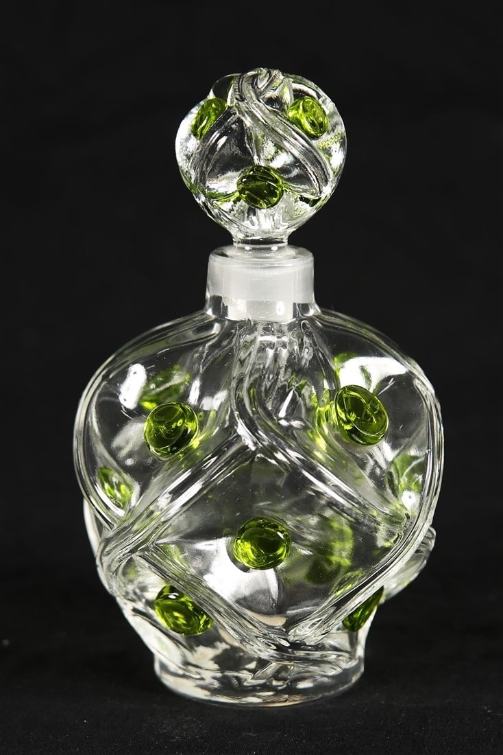 Lalique, Green "Floride" Flacon: Lalique (France, established 1888). "Floride" flacon. Glass. Height: 6", Diameter: 3 1/2". Lalique green glass "Floride" flacon with stopper. Sandblasted "Lalique France" to the underside.