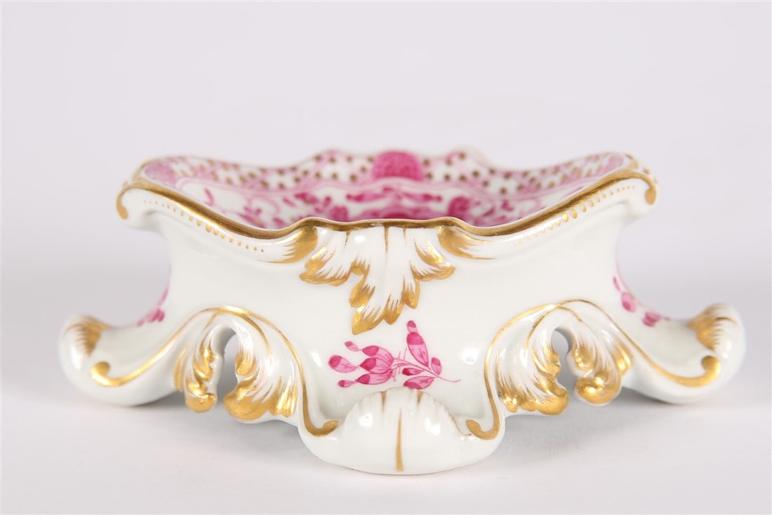 Meissen, Porcelain Rococo Salt Bowl: Meissen (German, established 1710). Porcelain. Height: 1 1/2, Length: 4 1/4, Depth: 3 1/4". Porcelain hand-painted salt bowl. Gilt edges with pink decoration. Crossed sword logo, illegible engraved nu