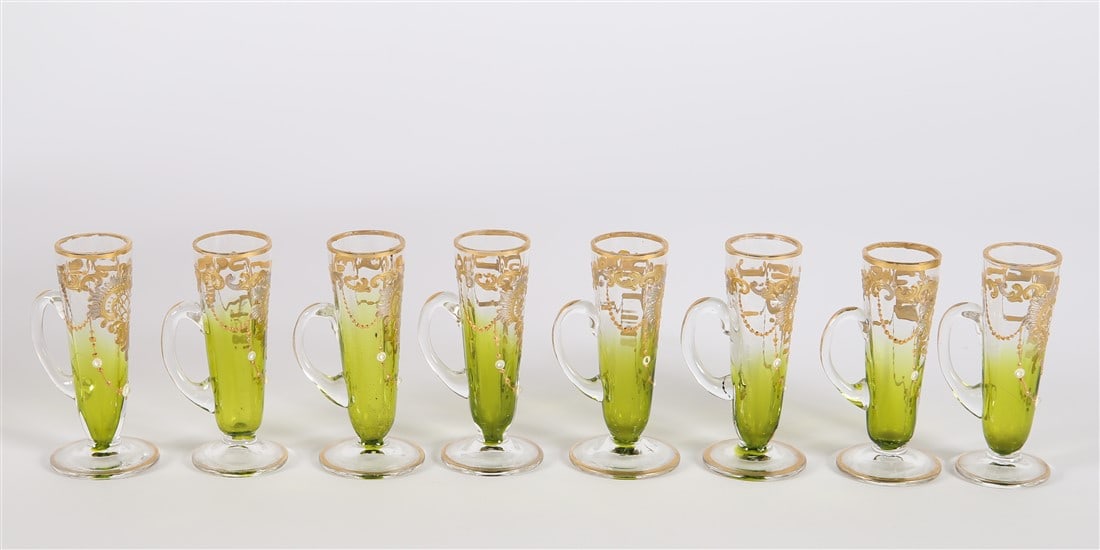 Set Of 8 Bohemian Style Glass Cordials: Painted glass. Height: 3 1/8", Diameter: 1 1/2". Bohemian style set of eight glass handled cordial glasses with gold painted designs.