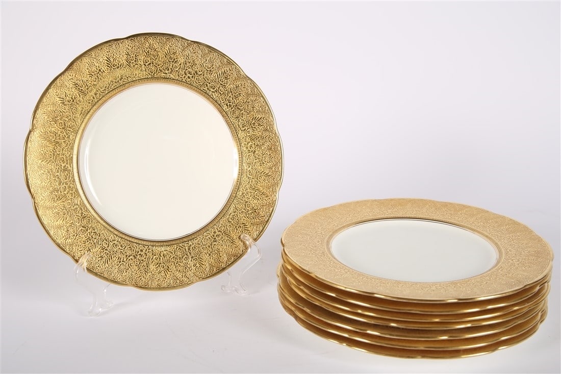 Mintons for Ovington Bros., Gold Rimmed Plates: Mintons. Porcelain. Produced for Ovington Brothers. Diameter: 10 1/4". Collection of eight (8) porcelain plates with gold rims produced by Mintons for Ovington Brothers. Detailed rims have floral and