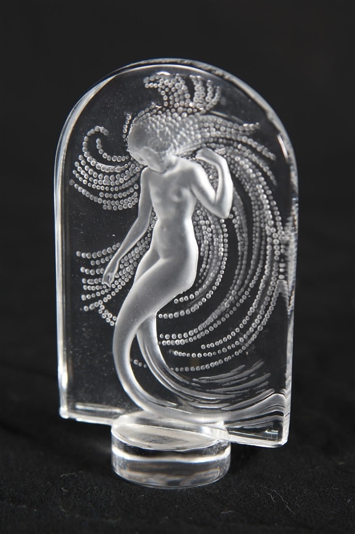 Lalique, "Naiade" Crystal Paperweight: Lalique (French, established 1888). "Naiade" paperweight. Crystal. Height: 3 3/4", Length: 2 1/4", Depth: 1". Crystal figurine depicting a water nymph by Lalique. Etched signature to side of base, sti