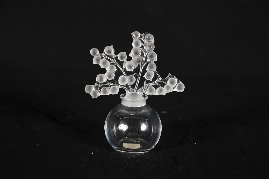 Lalique, "Clairefontaine" Crystal Perfume Bottle: Lalique (French, established 1888). "Clairefontaine" perfume bottle. Crystal. Height: 4 1/2", Length: 3 3/4", Depth: 2 1/4". "Clairefontaine" crystal perfume bottle by Lalique. Frosted Lily of the Val