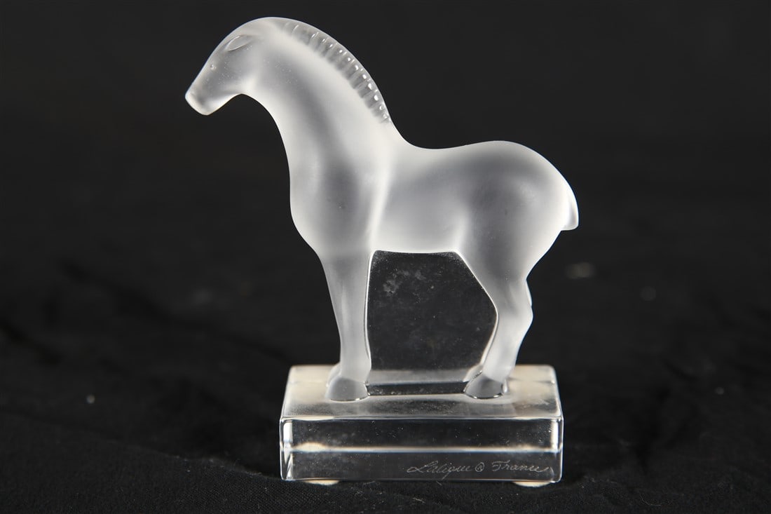 Lalique, "Tang" Frosted Crystal Horse Figurine: Lalique (French, established 1888). "Tang" horse. Frosted crystal. Height: 3 7/8", Length: 3 1/2", Depth: 1 3/8". Frosted crystal "Tang" horse figurine by Lalique. Lalique sticker to the underside. Et
