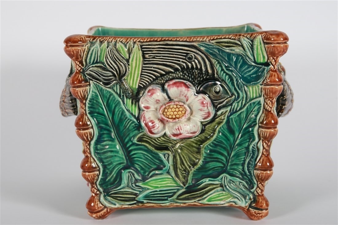 Square Majolica Floral Planter: Glazed ceramic. Height: 8 1/2", Length: 11 1/2", Depth: 8 1/2". Glazed ceramic majolica square planter featuring florals and birds to the sides.