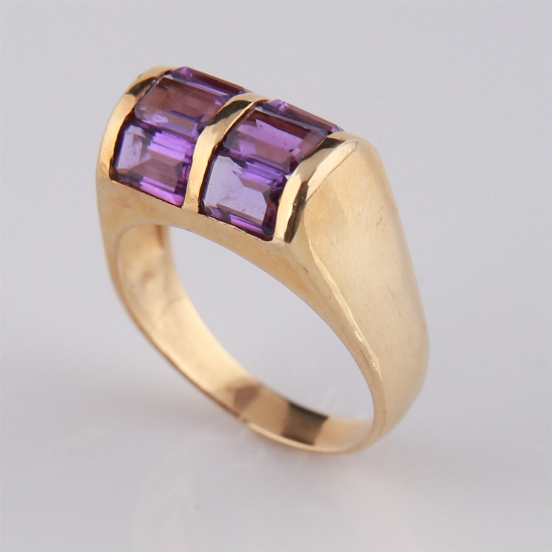 14k Yellow Gold Amethyst Ring: 14k yellow gold ring with six emerald-cut amethyst stones. Marked to the interior of the band "585". Size: 9.5. Total weight: 6g.
