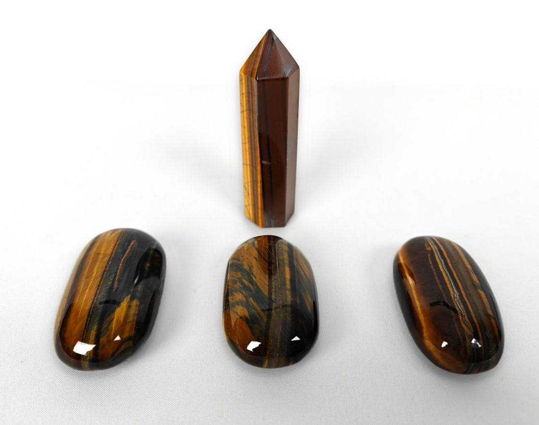 Three Tumbled Tiger Eye Stones, One Obelisk 255g: Collection of four tiger eye stones, including three (3) tumbled stones and one (1) obelisk. Tumbled stone dimensions: approx. 2" x 1" x 3/4". Obelisk stone dimensions: 1" x 1" x 3". Total Weight: 255