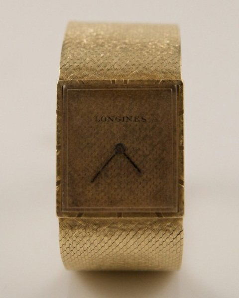 Longines 14K Gold Watch, C. 1970: Longines 14K gold watch. Circa 1970. Seventeen jewel movement. Diameter of watch 2", width of band and face1". Total weight 58.0 grams.
