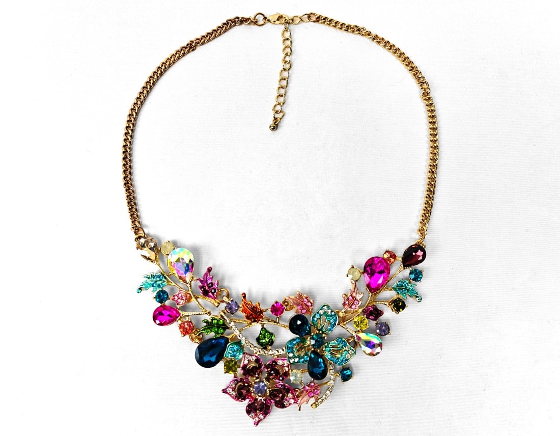 Gold-tone Floral Rhinestone Necklace: Gold-tone costume jewelry necklace made of colorful rhinestones with floral motif.