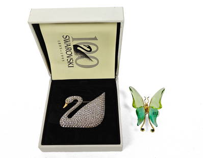 Swarovski, Two Vintage Brooches: Swarovski, two vintage brooches. Included are one swan brooch set with many white crystals, and a gold-plated sterling silver butterfly brooch with green crystal wings. Pictured original box included.