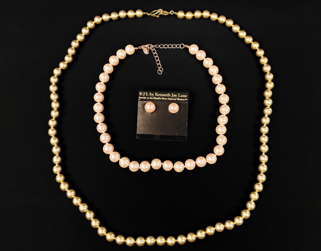 Kenneth J. Lane, Two Faux Pearl Necklaces: Kenneth J. Lane, two faux pearl necklaces. One gold-colored double-length necklace and one pink-colored necklace with matching earrings.