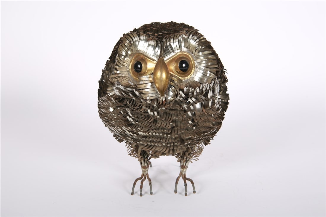 Sergio Bustamante, Cut Metal Owlet Sculpture: Sergio Bustamante (Mexican, b. 1949). Welded and cut brass and metal. Height: 9", Diameter: 7". Cut and welded metal sculpture in the shape of an owl or owlet. Black eyes. Each tuft is made of cut met