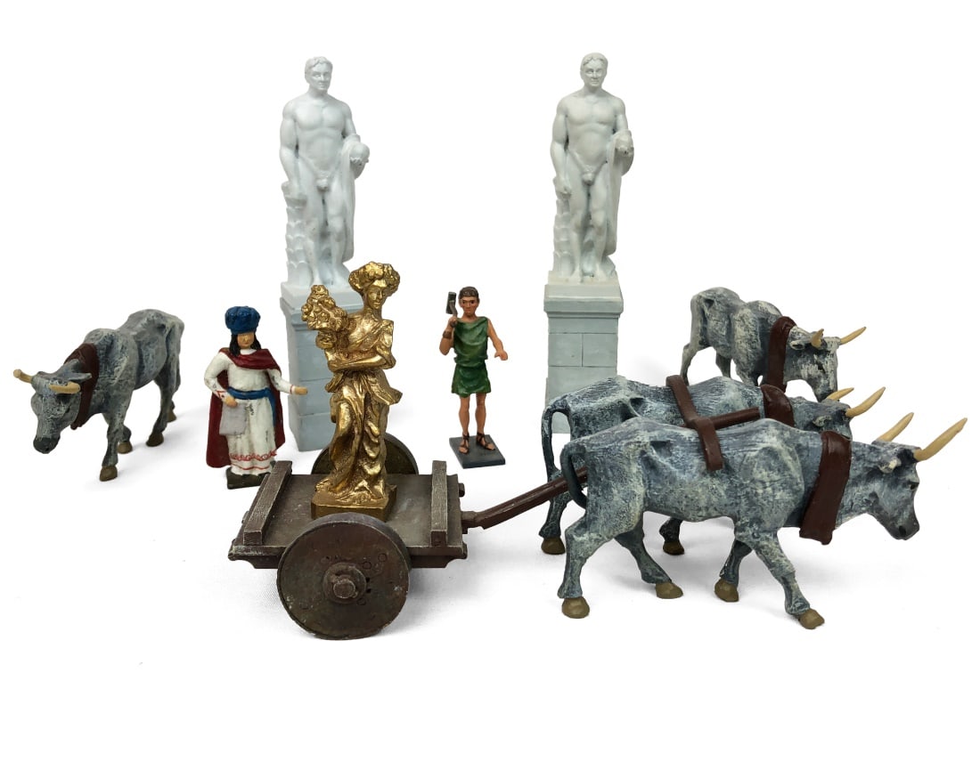 Ten-piece set of Roman Figures: Unbranded. Hand Painted. Set includes four oxen with cart, golden statue, merchant figurine, slave figurine, and two male figure statues.