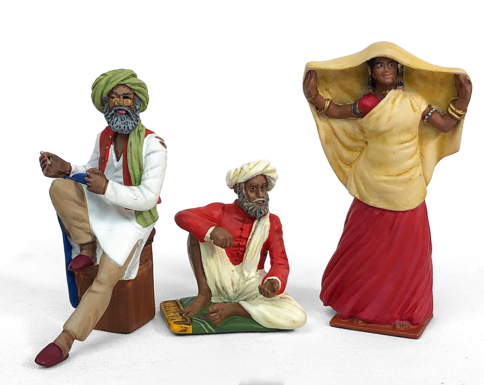 Britains - Three Delhi Durbar Figurines: Lot includes:22005 - Late Afternoon - Indian Woman. Unknown Number - Seated Indian Elder. 22004 - An Indian Tailor.All from the Delhi Durbar Collection.