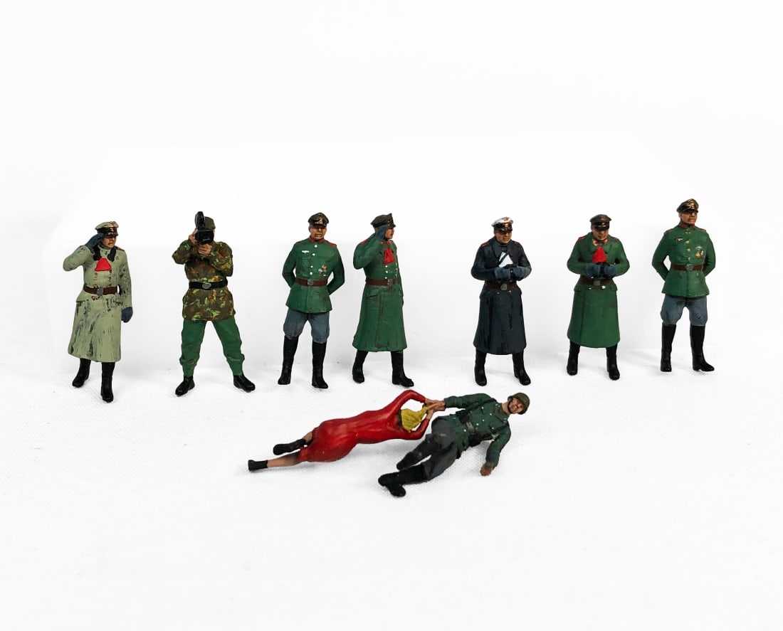 Set of 8 Unbranded 1 in. German Military Figurines: Figures are 1/72 scale, approx. 1 in. tall. They appear to be hand painted lead. They are unbranded.