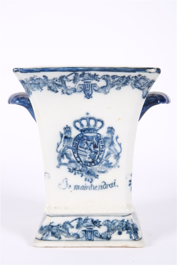 Blue and White Delftware Vase: Ceramic. Height: 7 3/4", Length: 8", Depth: 6 1/4". Blue and white Delftware vase which depicts the motto of the house of Orange Nassau and Netherlands. Decorative border at top and base. Maker's mark