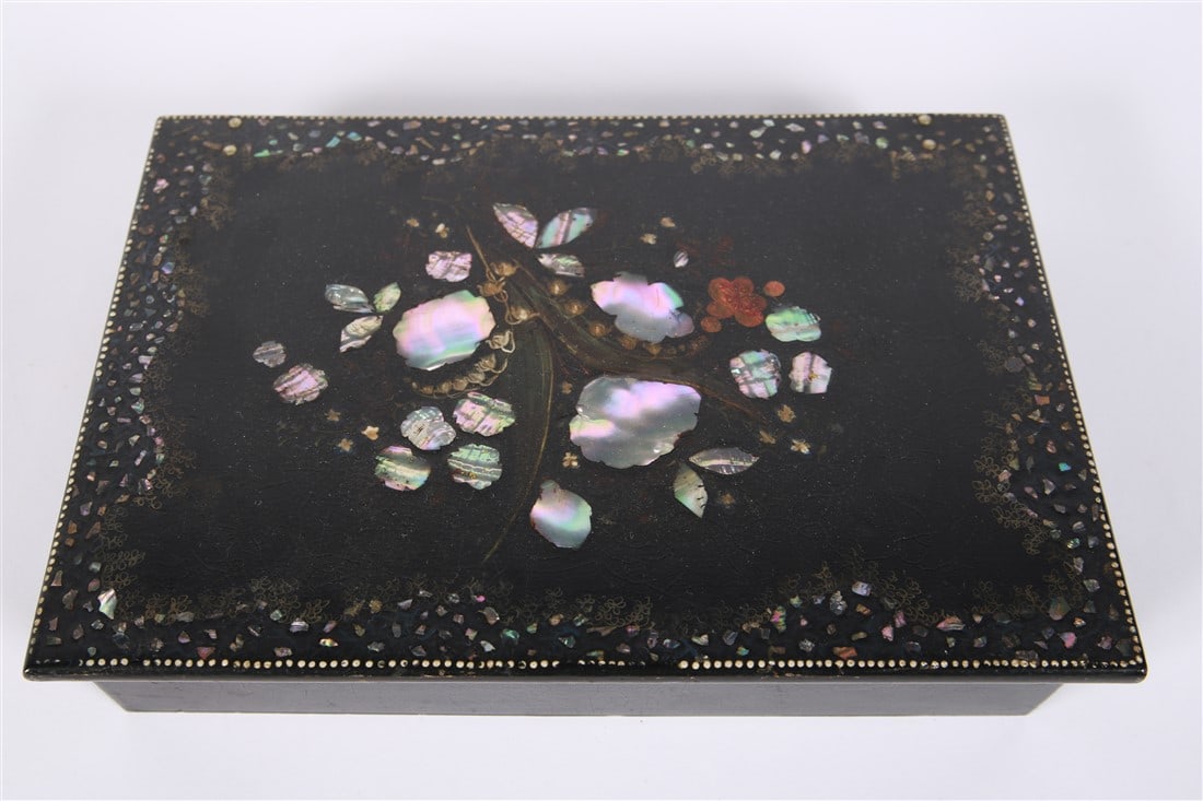 Inlaid Lap Desk: Papier mache with mother of pearl. Height: 3 1/4", Length: 12 3/4", Depth: 9". Black papier mache lap desk with mother of pearl inlay and painted border. Box opens to reveal a red velvet lined surface