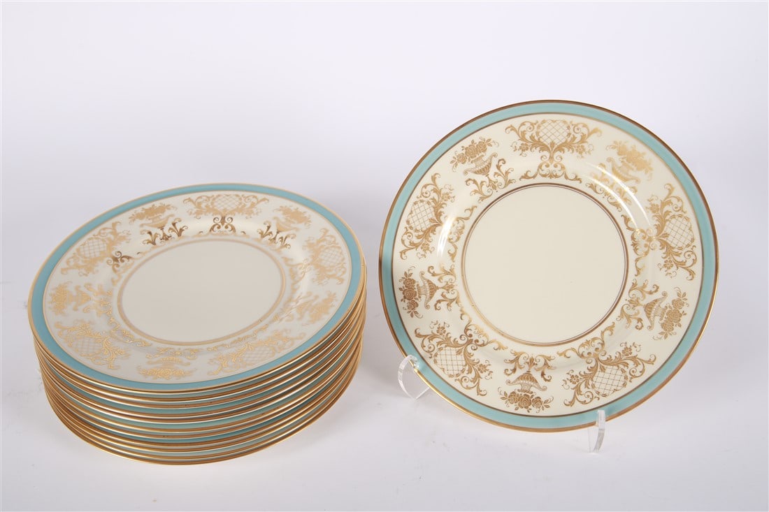 Set of Twelve Concorde China Dinner Plates: Concorde. Porcelain. Diameter: 10 5/8". Set of twelve white porcelain dinner plates with light blue and gilded decoration. Marked "Fine Concorde China" with wreath decoration on back.