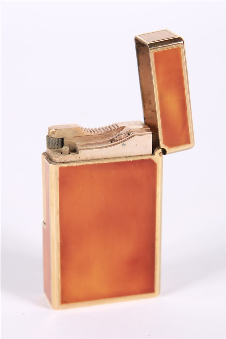 S.T. Dupont, Laque de Chine Lighter: S.T. Dupont (French, established 1872). Enamel, metal. Height: 2 1/4", Length: 1 3/8", Depth: 1/2". S.T. Dupont laque de chine lighter. Tortoiseshell style amber lacquered case with gold plated frame.