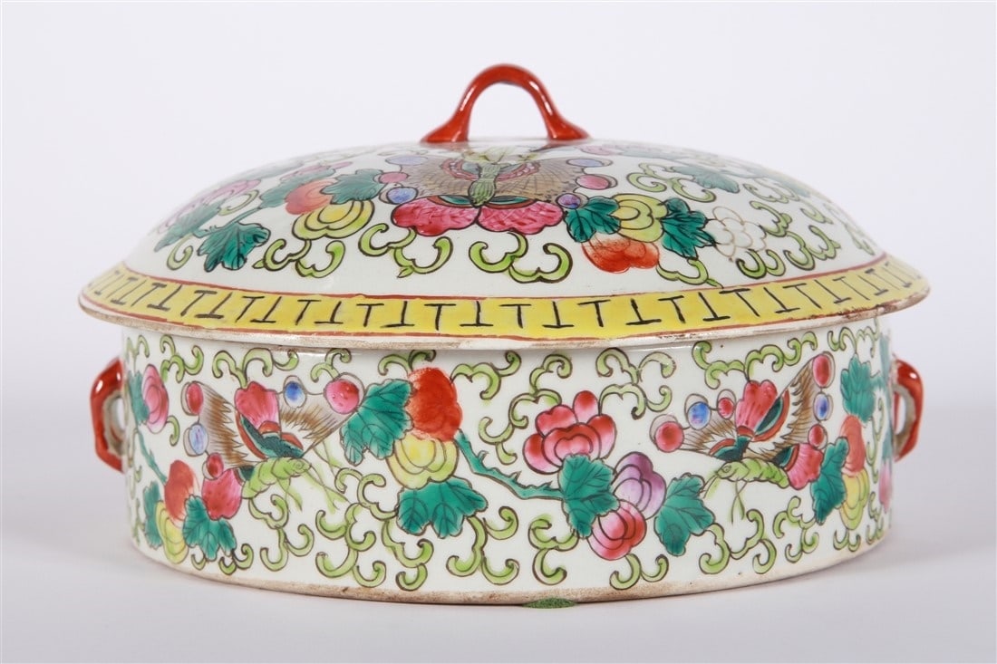 Chinese Famille Rose Lidded Vessel: Porcelain. Height: 4 1/2", Diameter: 7 1/2". Chinese famille rose porcelain low dish with lid. Dish with double red handles. Lid with one red handle. Decorated with florals and butterflies. Appears un