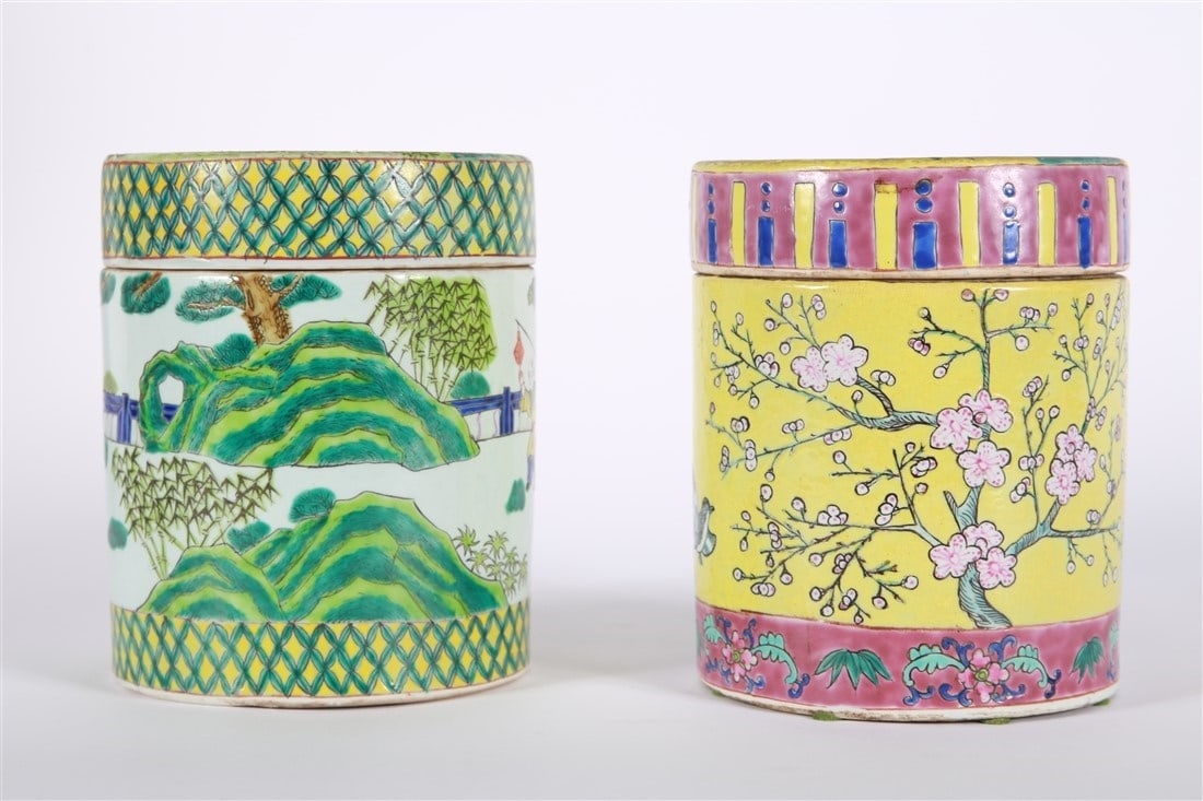Two Chinese Porcelain Lidded Jars: Porcelain. Height: 7", Diameter: 5 3/4". Two Chinese porcelain lidded jars. One with yellow ground depicting trees and flowers, the other with a blue ground depicting figures. Neither marked.
