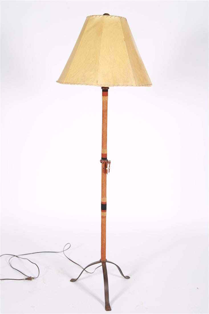 Native American Themed Floor Lamp: Metal, wood, faux suede, stone, beads, paper. Height: 62", Diameter: 16", Shade Diameter: 21". Native American themed floor lamp with faux suede wrap. Base wrapped with beads, faux arrowhead, etc. Pap