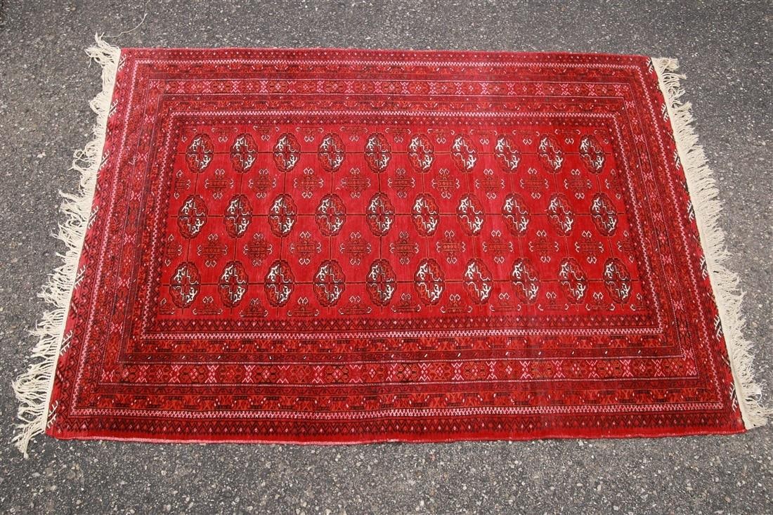 Pakistani Bokhara Rug, c. 1990s-2000s: Pakistan. Machine-spun wool, c. 1990s-2000s. 6'5" x 4'6". Pakistani Bokhara rug with red ground and geometric patterns.