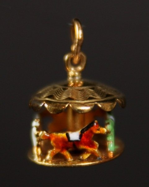 14K Gold Carousel Charm with Piano Charm: Two gold charms. 20th century. One 14 karat gold moveable carousel charm together with one 10 karat gold piano charm with moveable lid. Total weight 5 grams. Condition: Piano with one missing foot.