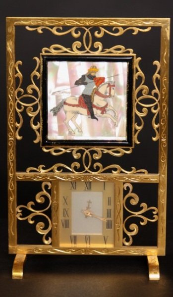 Brass and Mother of Pearl Desk Clock, 20th C.: Brass and mother of pearl desk clock. French, 20th century. Pierced trestle form frame inset with mother of pearl and ivory plaque of a knight, over a clock with Roman numeral face. Height 8 1/2", wid