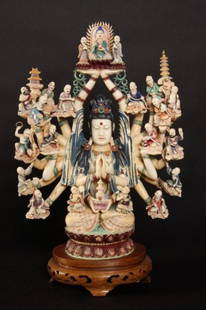 Carved Ivory and Enameled Bodhisattva, 20th C.: Carved ivory and enameled Bodhisattva. Chinese, 20th century. Seated Bodhisattva with outstretched arms supporting figures. Height 16", width 10 3/4". Condition: Multiple cracks to the body. The pigme